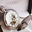 Load image into Gallery viewer, A silver-plated, skeleton double hunter pocket watch with a white Roman dial, displayed in an open case, showing the intricate mechanical movement and the brand's engraving on the front.